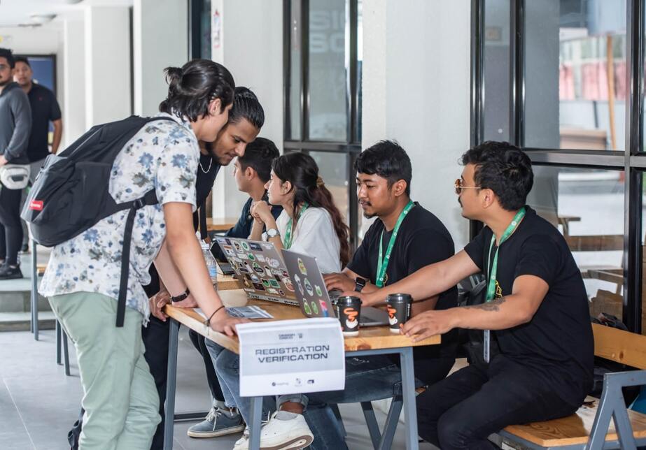 Oranizers check in participants at the registration booth before the event commences